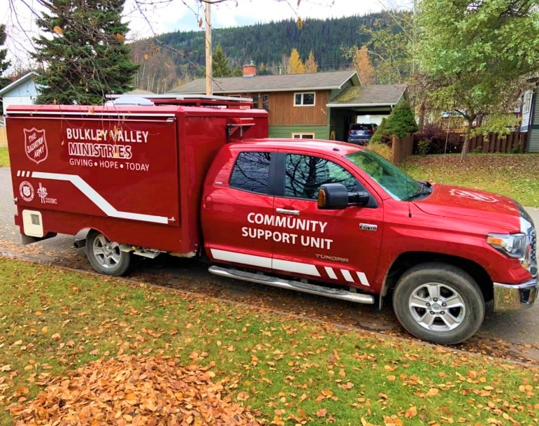 Red Salvation Army Bulkley Valley Ministries community support unit truck parked outdoors, used for outreach and community assistance services.