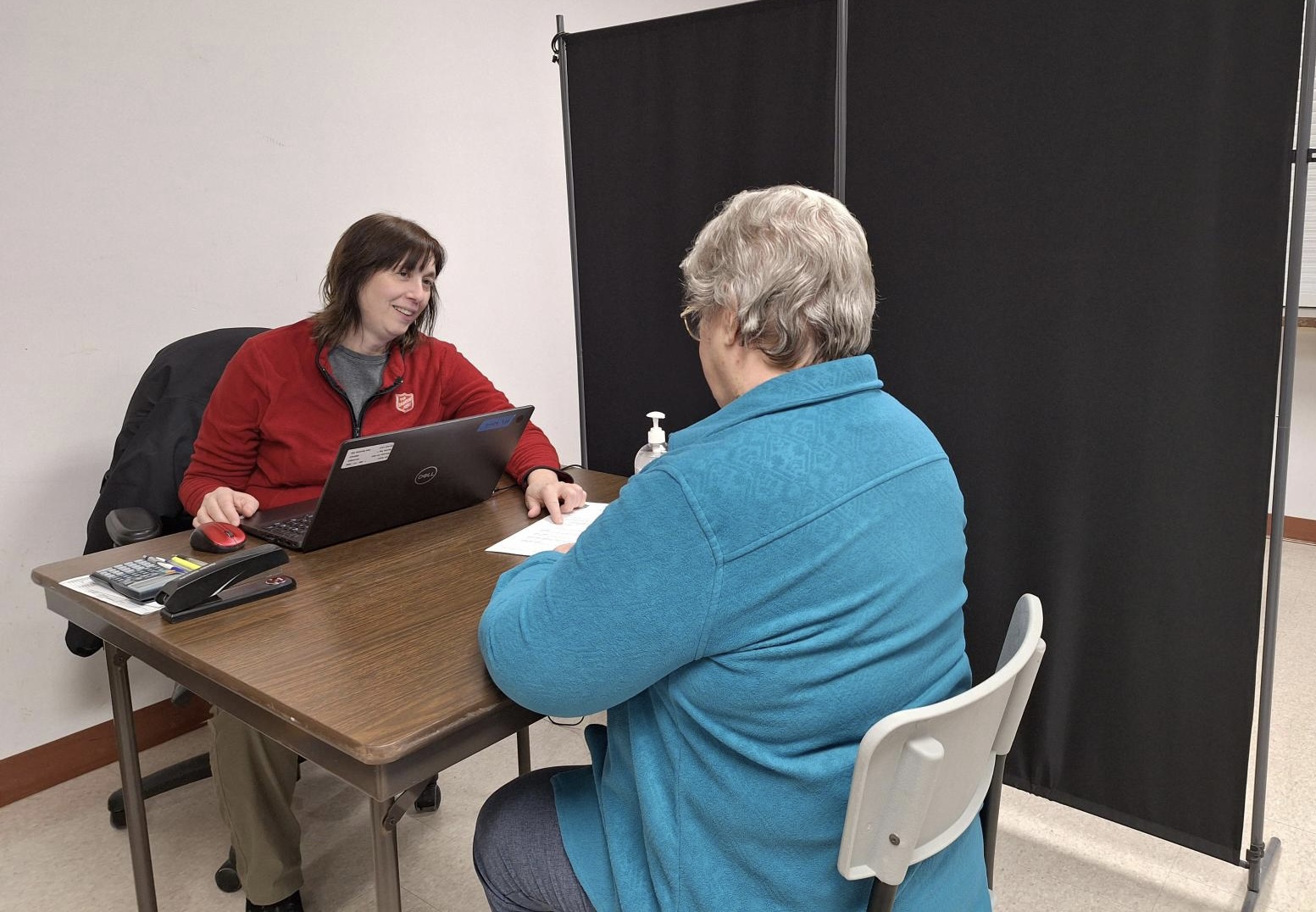 Salvation Army worker guides client through tax preparation 